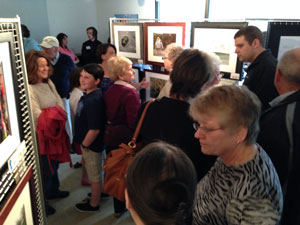 Members of the general public admiring the work of our Photography Beyond the Basics class at a gallery art show